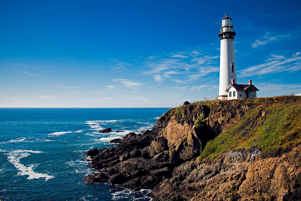 white lighthouse under cloudy sky